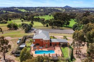 an aerial view of a house with a swimming pool at Centelle Park Farm Stay in Kilmore East