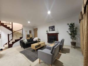 a living room with two couches and a fireplace at Centelle Park Farm Stay in Kilmore East