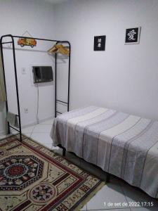 Tempat tidur dalam kamar di Cantinho Bonsai