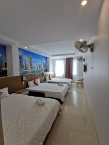Postel nebo postele na pokoji v ubytování Sen Vàng Hotel