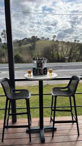 a table and two chairs on a porch with a window at Woomargama Motel in Woomargama +7 photos