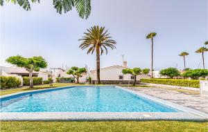 a swimming pool in a yard with palm trees at Gorgeous Home In Gran Canaria With Outdoor Swimming Pool in Pasito Blanco