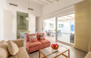 a living room with a couch and a table at Nice Home In Gran Canaria With Outdoor Swimming Pool in Pasito Blanco