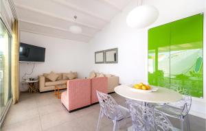 a living room with a table and a couch at Amazing Home In Gran Canaria With 3 Bedrooms, Wifi And Outdoor Swimming Pool in Pasito Blanco