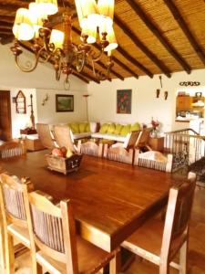 a dining room with a large wooden table and chairs at casa calima in Calima