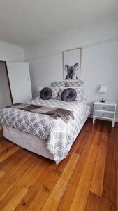 a bedroom with a bed with two dogs on it at 3 bedroom Art Deco home with modern features in Burnie