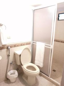 a bathroom with a toilet and a shower stall at casa calima in Calima