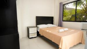 a small bedroom with a bed and a window at Garden Vista Hotel in Davao City
