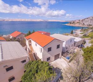 an aerial view of a house next to the water at Apartments by the sea Ribarica, Karlobag - 15907 in Ribarica