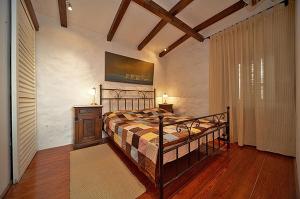 a bedroom with a bed and a table and a window at Apartments with a swimming pool Radovcici, Dubrovnik - 15908 in Gruda