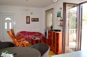 a living room with a table and chairs and a dining room at Apartments by the sea Rogac, Solta - 16223 in Grohote