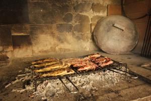 a bunch of food cooking on a grill at Apartment Vis 2470b in Vis