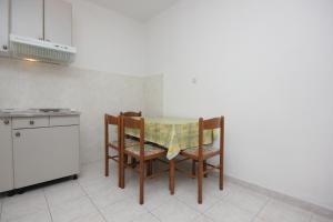 a kitchen with a table and two chairs and a counter at Apartment Vis 2470b in Vis +14 photos