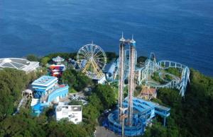 an amusement park with a ferris wheel and a roller coaster at Relaince international guest house in Hong Kong