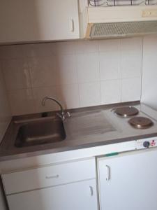 a kitchen with a sink and a counter top at Malia budget in Pírgos