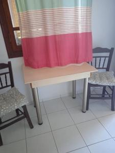 a curtain on a table with two chairs at Malia budget in Pírgos