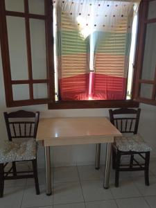a table and two chairs in front of a window at Malia budget in Pírgos