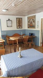 a dining room with a table with a blue and white table cloth at Skogshemmet in Ludvika