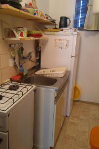 a small kitchen with a sink and a refrigerator at Apartments and rooms with parking space Stari Grad, Hvar - 14888 in Stari Grad