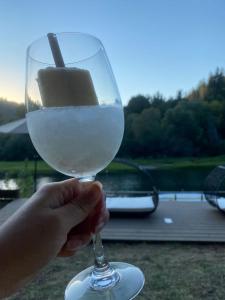 a person holding a glass of white wine at Boho Manor in Monte Rio