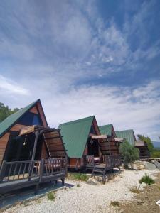 a row of log homes with green roofs at Patara Bungalov Houses 1 in Kaş