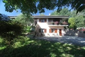 a large house with a balcony on the side of it at B&B Il Picchio in Mergozzo