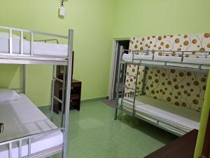 a room with three bunk beds in a dorm at Omah 365 Homestay in Sentool