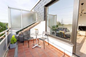 a patio with a table and chairs on a balcony at Cozy 4 room apartment in Hilden in Hilden