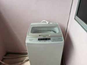 a fax machine sitting in the corner of a room at Aryani Homestay in Kampong Kelemak