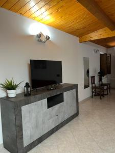 a large entertainment center with a flat screen tv on a wall at Casa Nico in Montemarciano