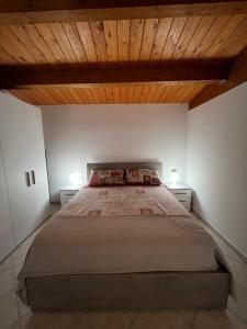 a bedroom with a large bed with two night stands at Casa Nico in Montemarciano