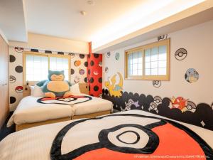 a childs bedroom with two beds with a captain america mural at MIMARU TOKYO UENO EAST in Tokyo