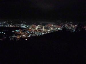 an aerial view of a city at night at Chalet entrenubes in Medellín