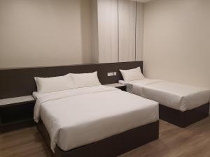 Rúm í herbergi á T SQUARE HOTEL (IPOH)