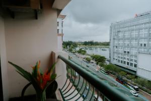 a balcony with a view of a river and buildings at Petronella Apartment C1 Marina Court in Kota Kinabalu