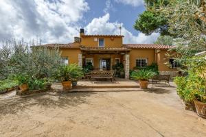 an exterior view of a house with a patio at Villa Casa Dolores Style Catalan in Begur