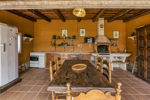 a kitchen with a large wooden table and a fireplace at Villa Casa Dolores Style Catalan in Begur