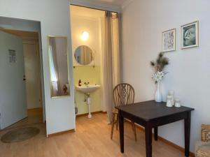 a dining room with a table and a sink at Skogshemmet in Ludvika