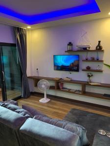 a living room with a couch and a tv at Smile Home Krabi Klong Moung Beach in Klong Muang Beach