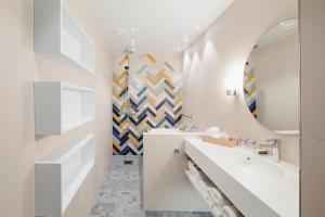 a bathroom with two sinks and a mirror at Hotel Indigo Helsinki-Boulevard, an IHG Hotel in Helsinki