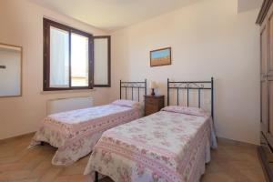 a bedroom with two beds and a window at Casale del Conero in Porto Recanati +61 photos