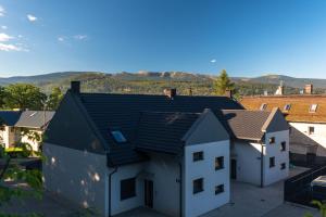 an aerial view of a house with mountains in the background at Apartament Widok 1 in Piechowice