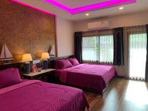 a hotel room with two beds and purple lighting at Smile Home Krabi Klong Moung Beach in Klong Muang Beach