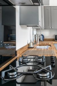 a kitchen with a stove top oven in a kitchen at Rock Pool Reach - central location with parking in Broadstairs