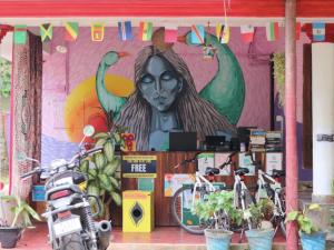 a building with a painting of a woman on the wall at HostelExp, Varkala - A Beach Town Hostel in Varkala