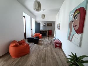 a living room with an orange couch and a table at Nuvoleinviaggio in Sulmona