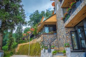 a building with flowers on the side of it at Sapa Pine Hill Eco Lodge in Sapa