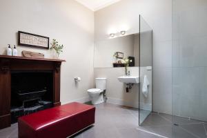 a bathroom with a toilet and a shower and a sink at Maple - quaint cottage with fireplace and spa in Daylesford