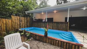 a swimming pool in the backyard of a house at Brand new huge apt with Air Conditioner and a private pool and kitchen in Cocles