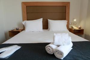 Ένα ή περισσότερα κρεβάτια σε δωμάτιο στο Perea Hotel 